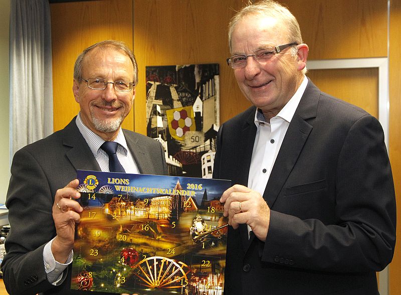Bürgermeister Roland Schäfer und Lionspräsident Reinhard Middendorf mit dem diesjährigen Weihnachtskalender dse Lionsclubs BergKamen